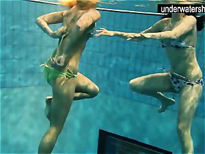 two sexy amateurs showing their figures off under water